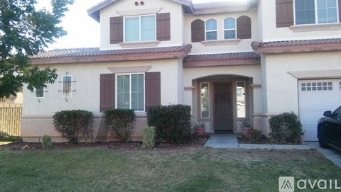 A house with brown shutters and a brown door is for sale.