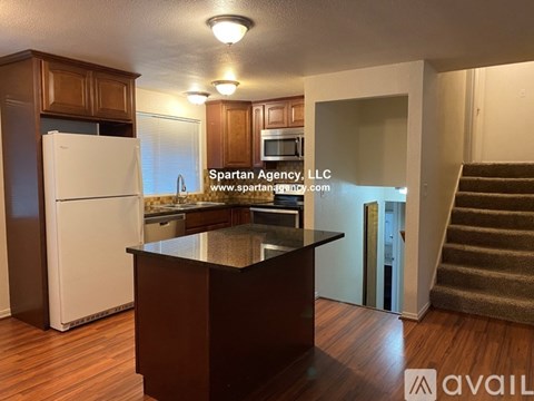 A kitchen with wooden cabinets and a white refrigerator.