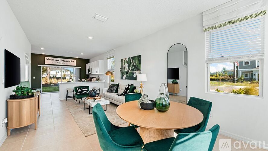 A living room with a dining table and chairs.