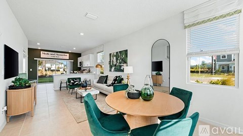 A living room with a dining table and chairs.