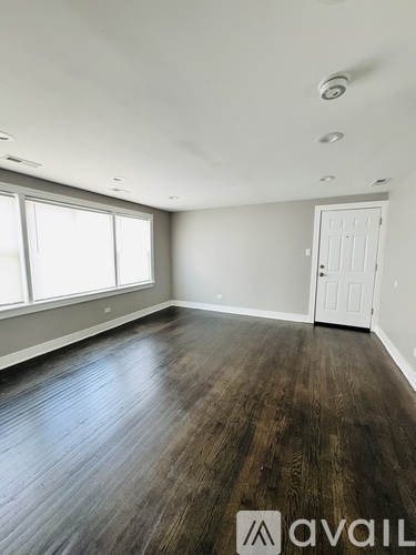 A room with wooden floors and a white door.