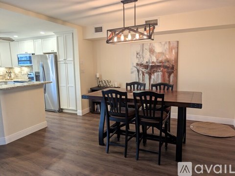 A kitchen with a dining table and chairs.