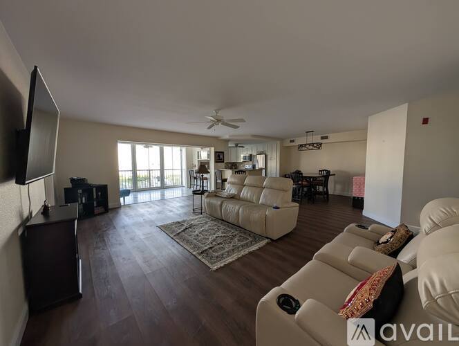 A living room with a flat screen TV mounted on the wall.