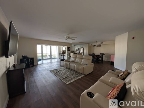 A living room with a flat screen TV mounted on the wall.