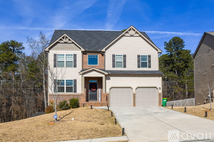 A two-story house with a garage is for sale.
