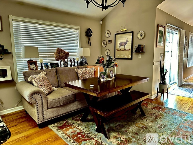 A living room with a couch, coffee table, and pictures on the wall.