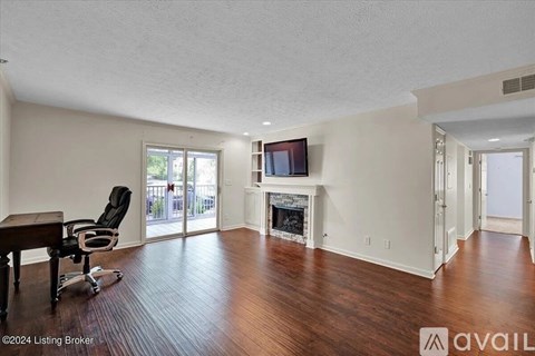 A living room with a fireplace and a television.