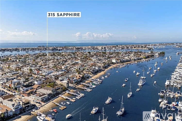A view of a harbor with boats and buildings, with the text "315 SAPPHIRE" in the upper left corner.