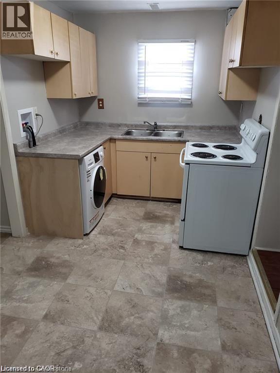 A kitchen with a washer and dryer built in.