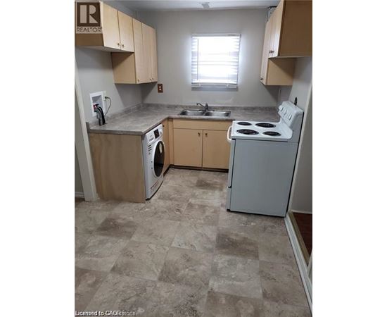 A kitchen with a washer and dryer built in.