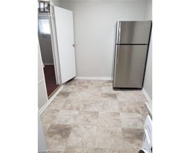 A kitchen with a fridge and a washing machine.