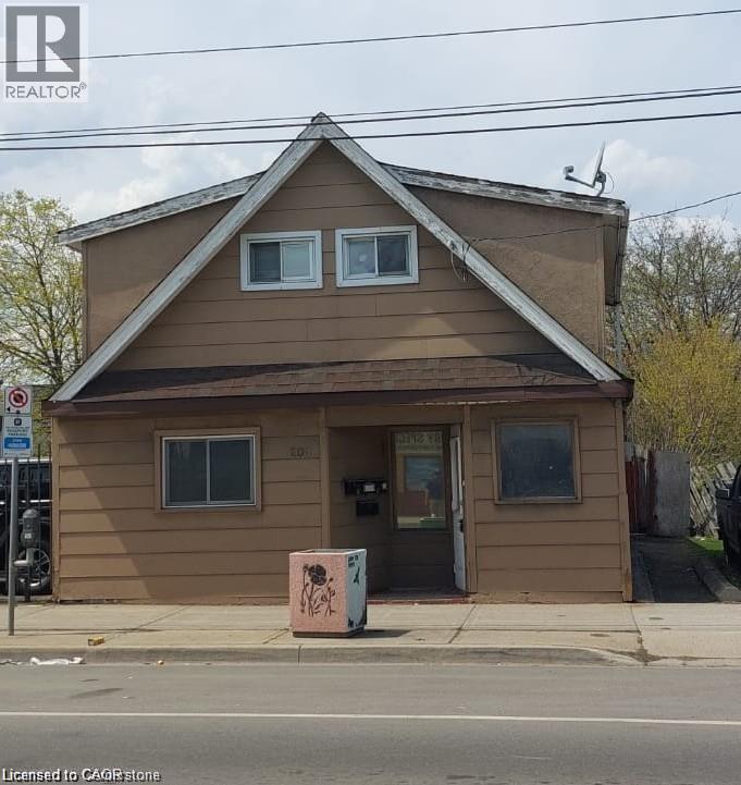 A small brown building with a window and a door.