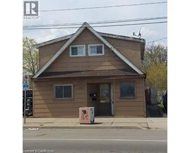 A small brown building with a window and a door.