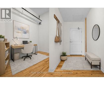 A well-lit room with a desk, chair, and a bench.