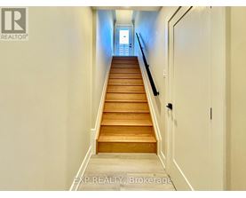 A long flight of wooden stairs leads to a door.