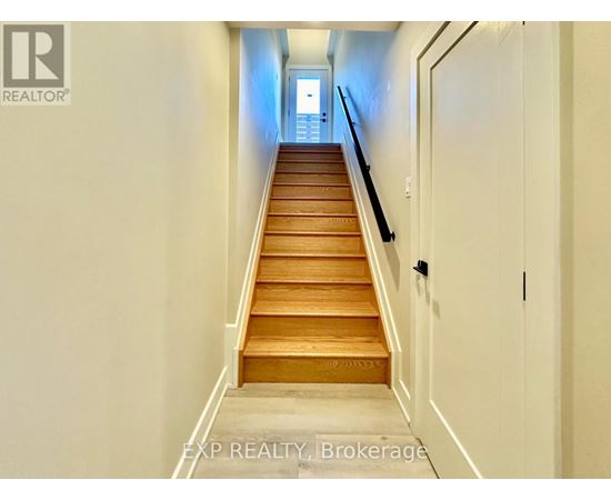 A long flight of wooden stairs leads to a door.