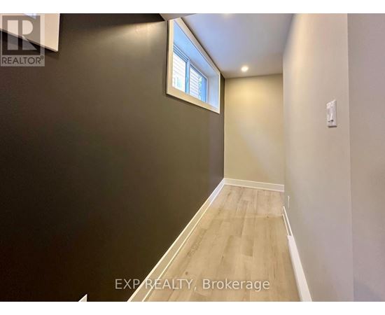 A room with a window and wooden flooring.