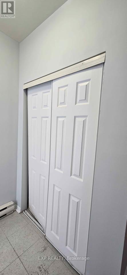 A white door in a room with white walls.