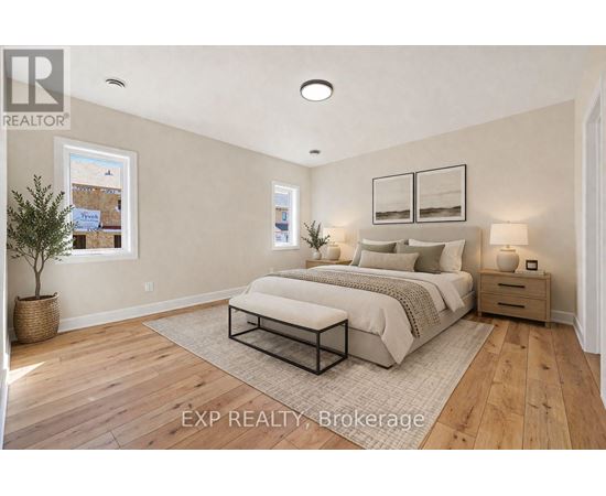 A bedroom with a large bed, a nightstand, and a small tree in a pot.