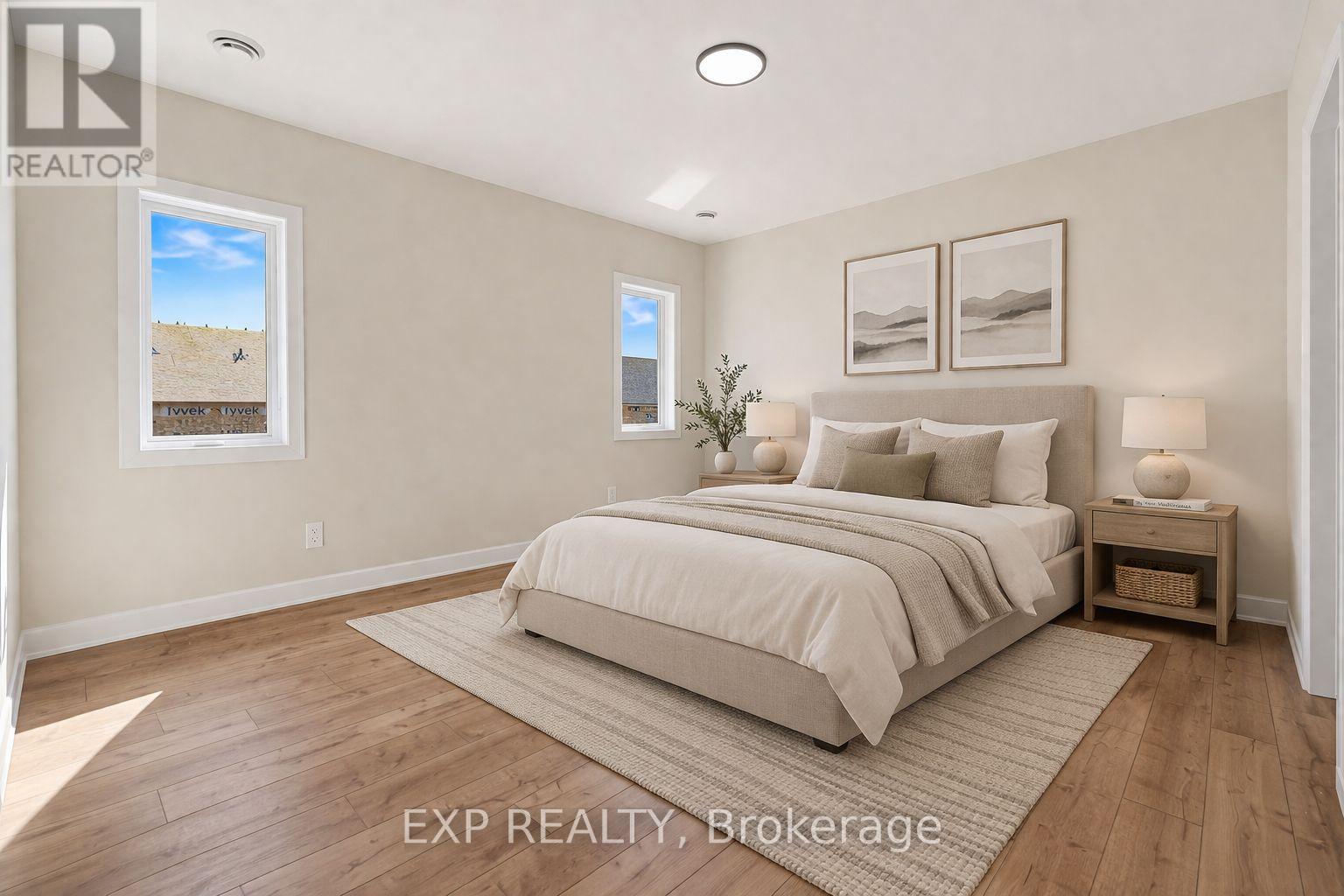 A bedroom with a large bed and a small plant on the nightstand.