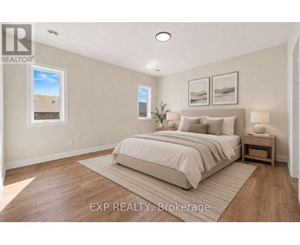 A bedroom with a large bed and a small plant on the nightstand.