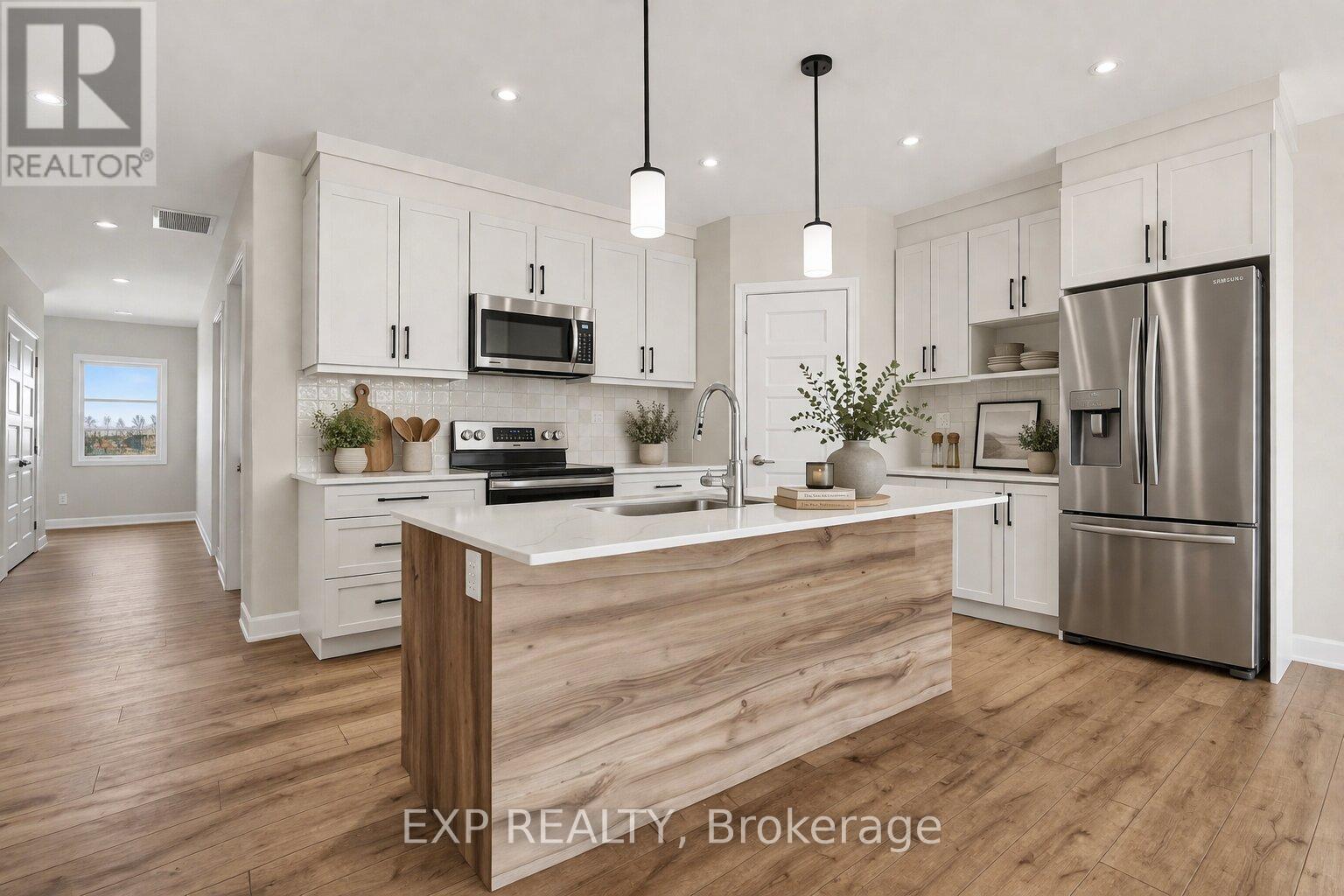 A modern kitchen with white cabinets and a wooden island.