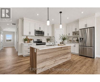 A modern kitchen with white cabinets and a wooden island.