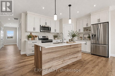 A modern kitchen with white cabinets and a wooden island.