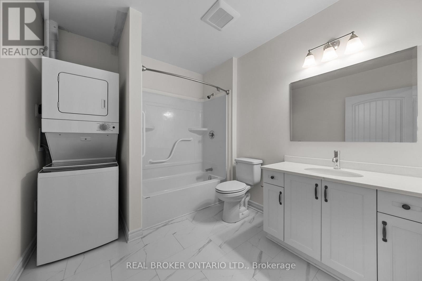 A bathroom with a toilet, sink, and a cabinet with a drawer.