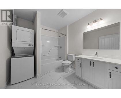 A bathroom with a toilet, sink, and a cabinet with a drawer.