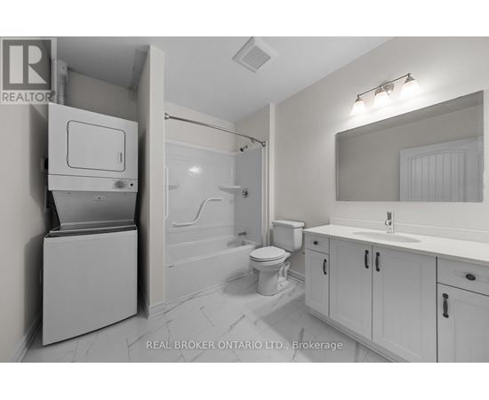 A bathroom with a toilet, sink, and a cabinet with a drawer.
