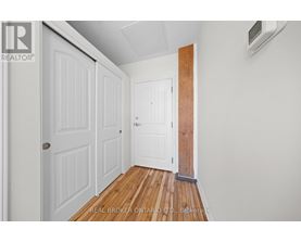 A hallway with white doors and a wooden floor.