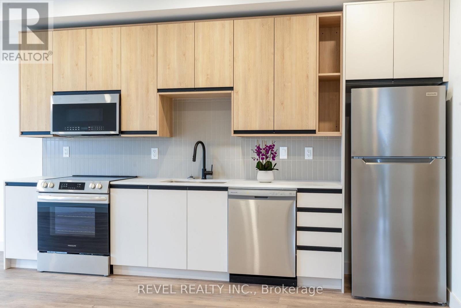 A modern kitchen with wooden cabinets and stainless steel appliances.
