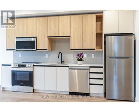 A modern kitchen with wooden cabinets and stainless steel appliances.