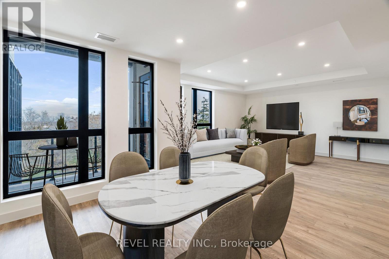 A modern dining room with a large table and chairs.