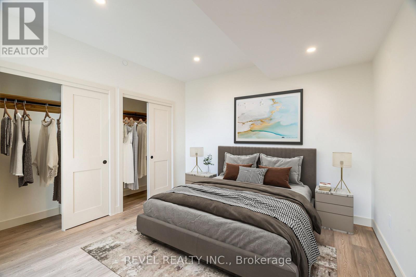 A bedroom with a large bed and a painting on the wall.