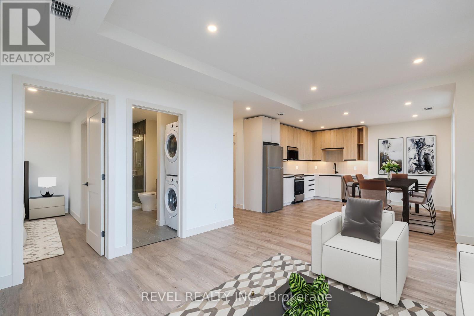 A modern living room with a washing machine and dryer built into the cabinetry.