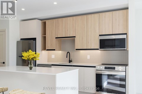A modern kitchen with wooden cabinets and stainless steel appliances.