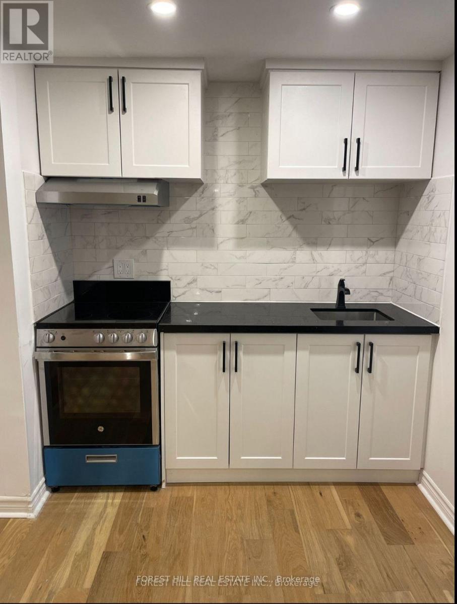 A kitchen with white cabinets and a blue oven.