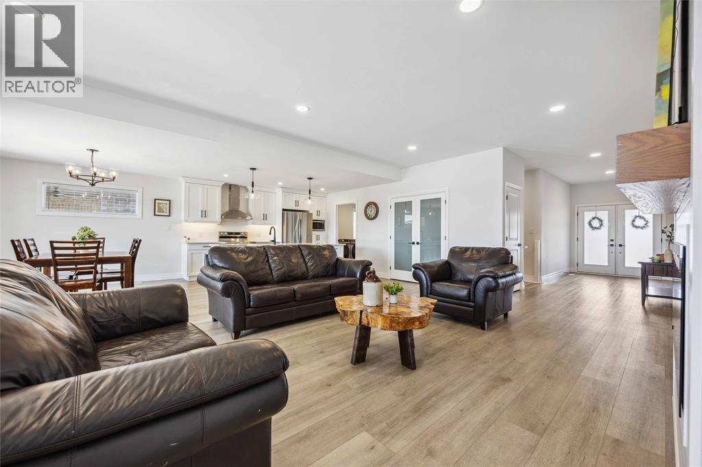 A living room with brown leather couches and a wooden coffee table.