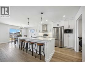 A modern kitchen with white cabinets and a large island.