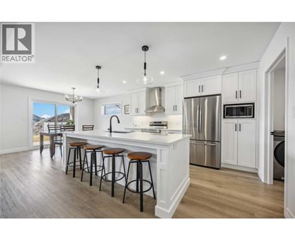 A modern kitchen with white cabinets and a large island.