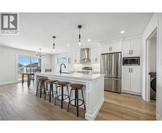 A modern kitchen with white cabinets and a large island.