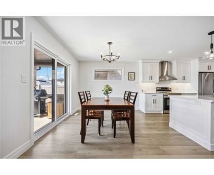 A dining room with a table set for two.