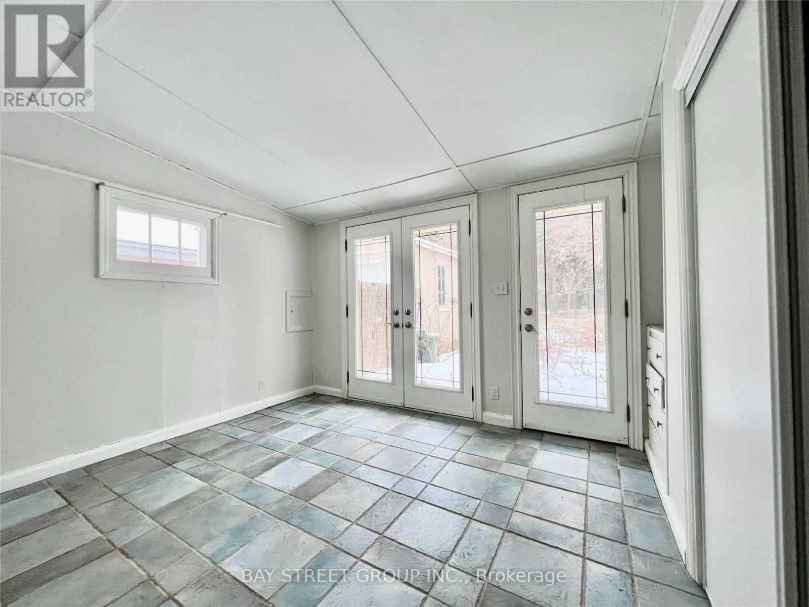 A room with a tiled floor and white walls.