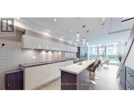 A modern kitchen with a large island and a dining area.