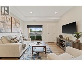 A living room with a couch, a coffee table, and a television.