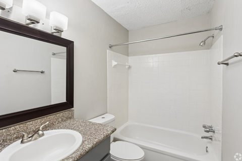A white bathroom with a sink, toilet, and bathtub.