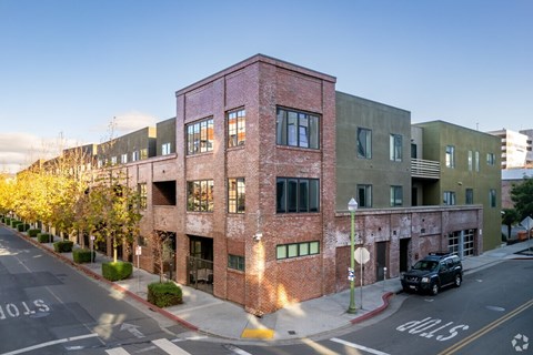A street view of a building with a car parked in front.