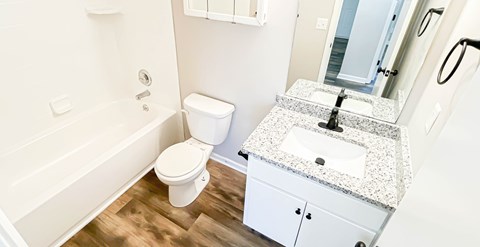 A white toilet sits next to a sink in a bathroom.